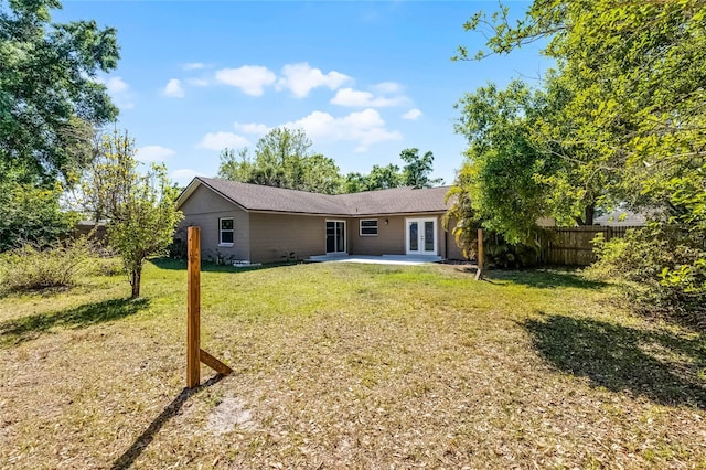 607 Wavecrest Dr, Orlando, FL 32807 - back of house featuring a patio area, fence, french doors, and a yard