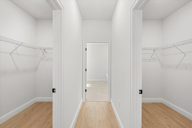 walk in closet featuring light wood-type flooring