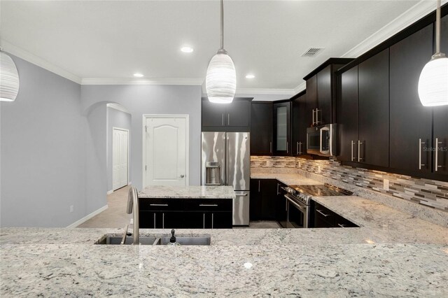 kitchen featuring tasteful backsplash, crown molding, visible vents, stainless steel appliances, and a sink