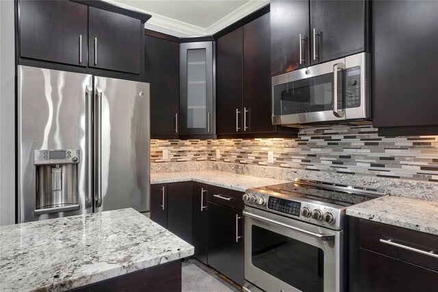 kitchen with crown molding, glass insert cabinets, backsplash, and stainless steel appliances