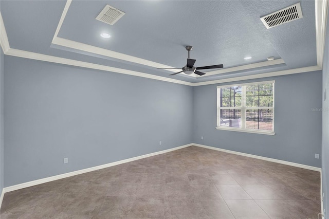 spare room featuring a tray ceiling, a textured ceiling, ceiling fan, and visible vents