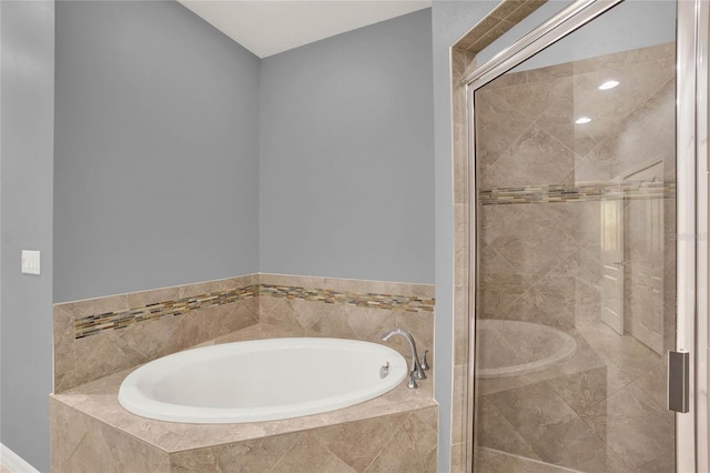 bathroom featuring a shower stall and a garden tub