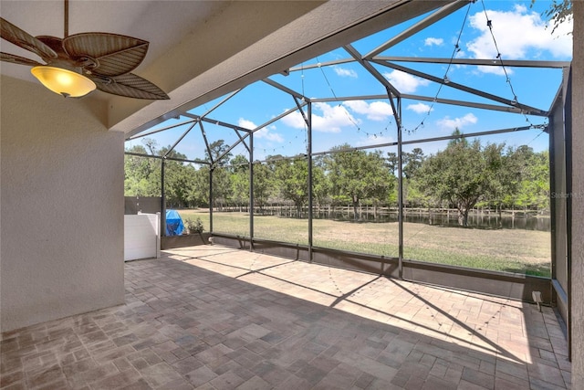 view of patio featuring glass enclosure and a ceiling fan