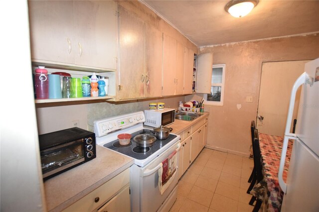 2220 Ave F NW, Winter Haven, FL 33880 - kitchen with a sink, light tile patterned floors, light countertops, and white appliances