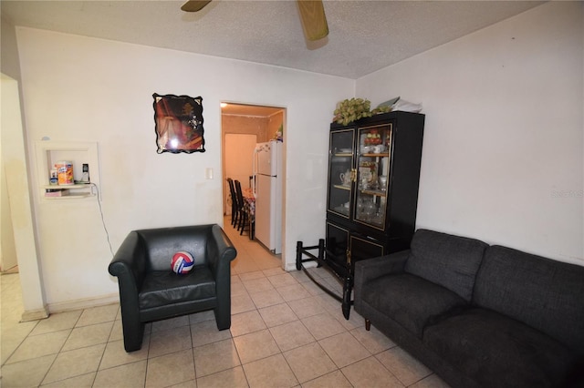 2220 Ave F NW, Winter Haven, FL 33880 - living area with light tile patterned floors, a textured ceiling, and ceiling fan