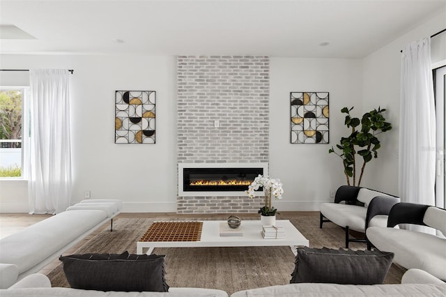 2408 Lafayette Ave, Winter Park, FL 32789 - living area with baseboards, a large fireplace, and wood finished floors