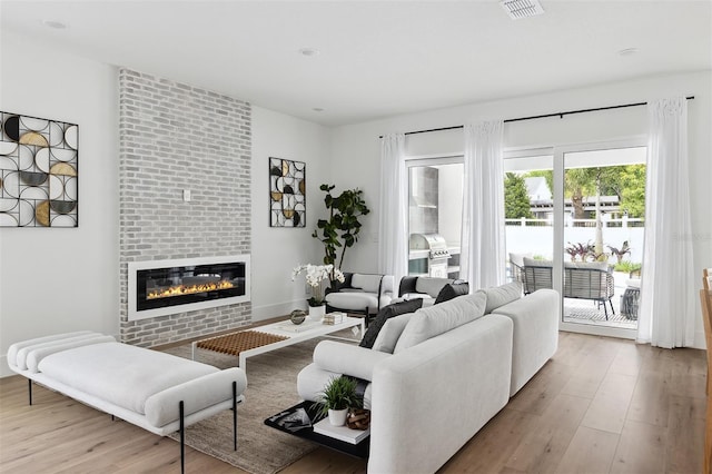 2408 Lafayette Ave, Winter Park, FL 32789 - living room with visible vents, a fireplace, and wood finished floors
