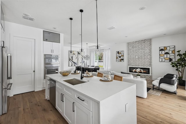 2408 Lafayette Ave, Winter Park, FL 32789 - kitchen with wood finished floors, a sink, appliances with stainless steel finishes, and visible vents