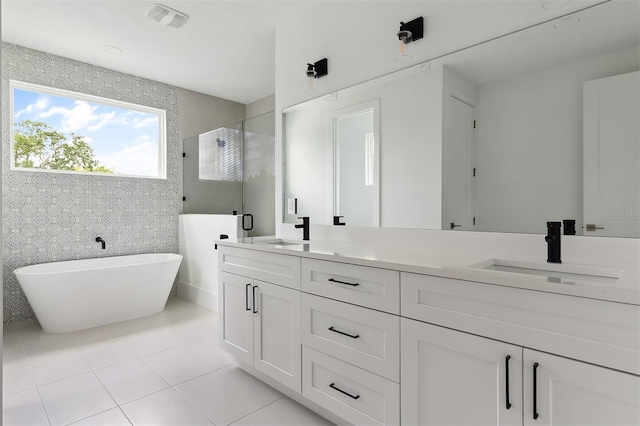 2408 Lafayette Ave, Winter Park, FL 32789 - bathroom featuring a soaking tub, tile patterned flooring, a sink, and a stall shower