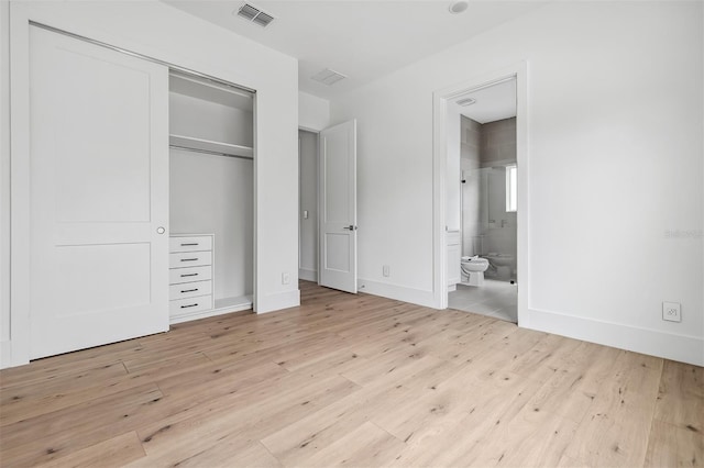 2408 Lafayette Ave, Winter Park, FL 32789 - unfurnished bedroom featuring baseboards, ensuite bath, light wood finished floors, visible vents, and a closet