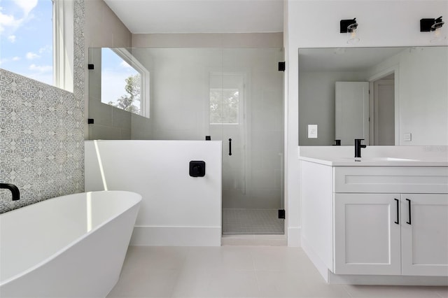 2408 Lafayette Ave, Winter Park, FL 32789 - full bathroom featuring tile walls, a soaking tub, tile patterned floors, vanity, and a stall shower