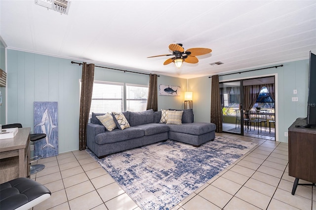 living room featuring light tile patterned flooring, visible vents, and plenty of natural light