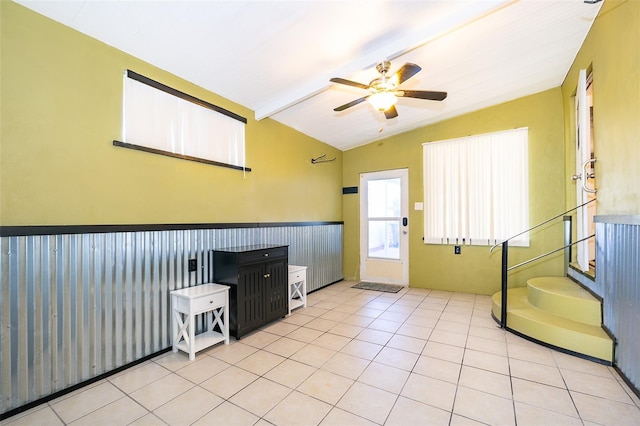 foyer with lofted ceiling with beams, ceiling fan, and light tile patterned floors