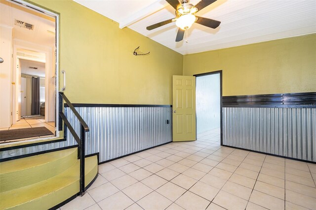 empty room featuring visible vents, ceiling fan, and light tile patterned floors