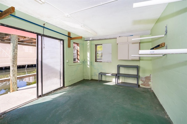 interior space featuring concrete block wall and concrete flooring