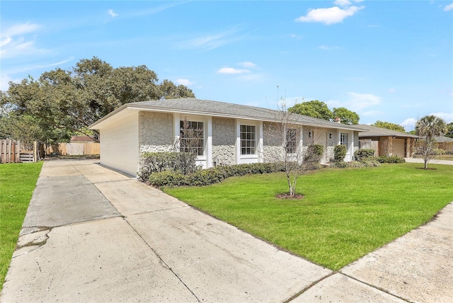 single story home featuring fence, stone siding, driveway, a front lawn, and a garage