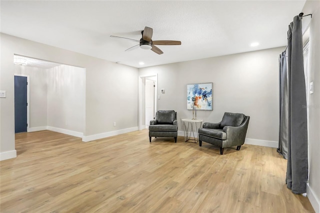 sitting room with baseboards, ceiling fan, light wood-style flooring, and recessed lighting