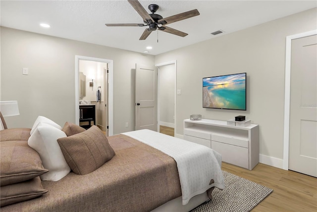 bedroom with recessed lighting, baseboards, connected bathroom, visible vents, and light wood-style flooring