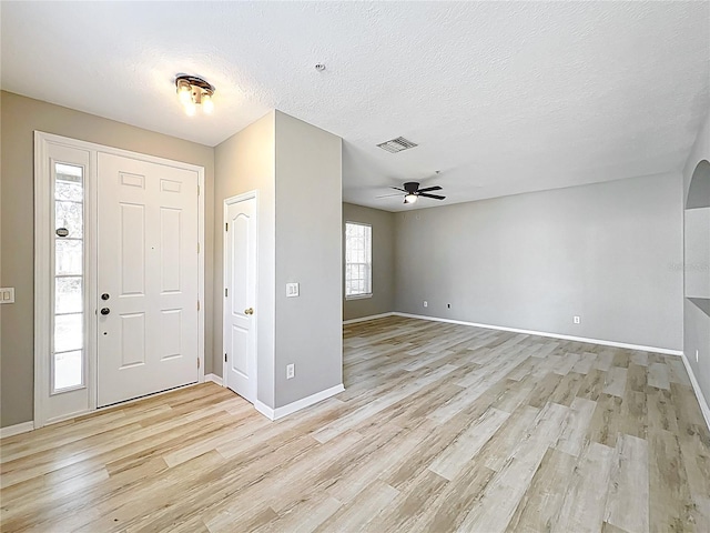 10852 Spider Lily Dr Unit S, Orlando, FL 32832 - foyer entrance with light wood finished floors, baseboards, a ceiling fan, and a textured ceiling