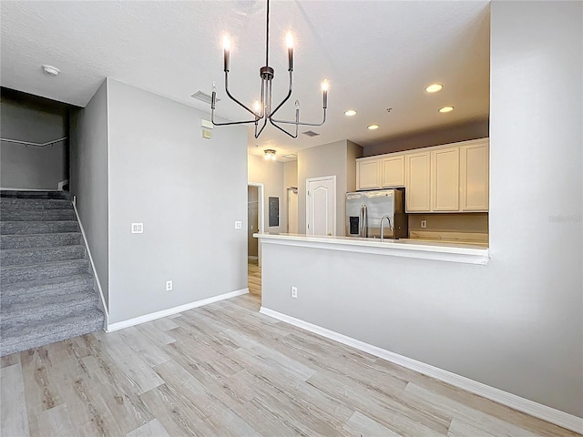 10852 Spider Lily Dr Unit S, Orlando, FL 32832 - kitchen featuring stainless steel fridge with ice dispenser, a chandelier, light wood finished floors, recessed lighting, and light countertops