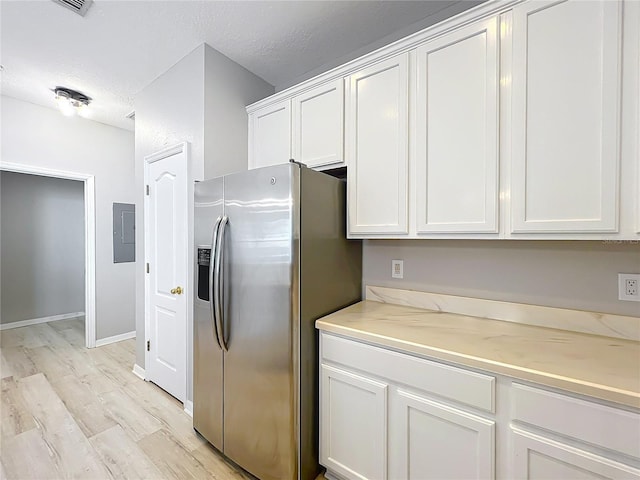 10852 Spider Lily Dr Unit S, Orlando, FL 32832 - kitchen featuring stainless steel fridge with ice dispenser, electric panel, light wood-type flooring, white cabinets, and a textured ceiling