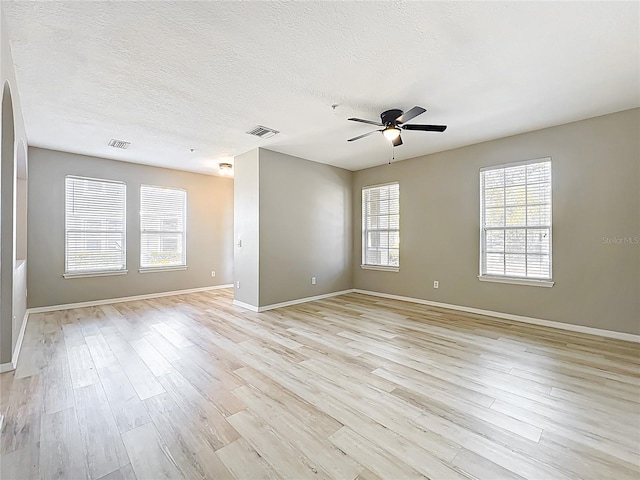 10852 Spider Lily Dr Unit S, Orlando, FL 32832 - spare room with light wood-style flooring, a ceiling fan, baseboards, and a textured ceiling