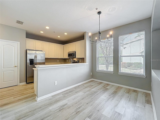 10852 Spider Lily Dr Unit S, Orlando, FL 32832 - kitchen featuring appliances with stainless steel finishes, a chandelier, light wood-style flooring, light countertops, and recessed lighting
