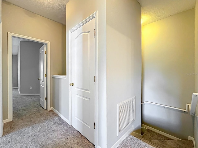 10852 Spider Lily Dr Unit S, Orlando, FL 32832 - hall featuring a textured ceiling, carpet floors, and baseboards