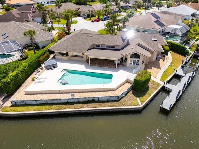 drone / aerial view featuring a residential view and a water view