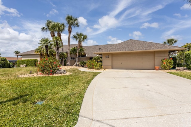 ranch-style house featuring driveway, a front yard, stucco siding, and a garage