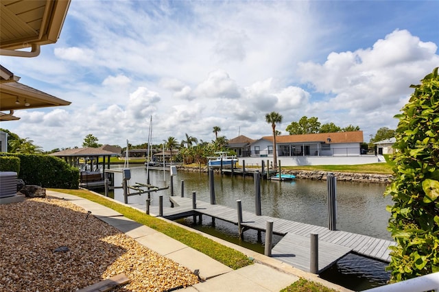 dock area with boat lift, central AC, and a water view