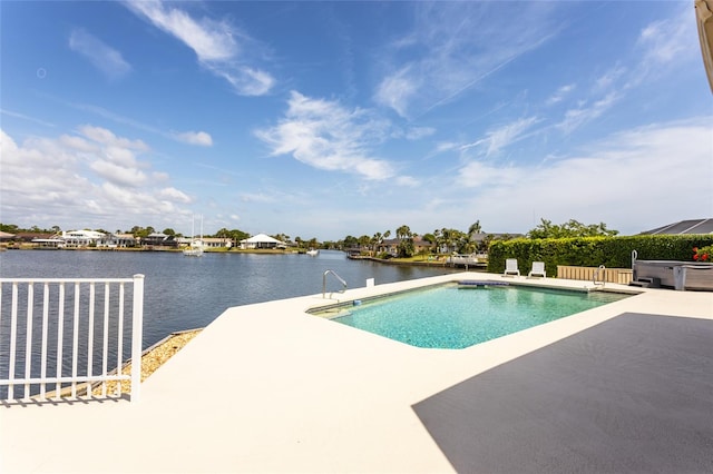 pool featuring a patio and a water view