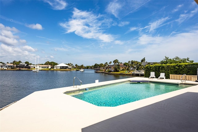 pool with a water view and a patio area