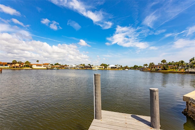 dock area featuring a water view and a residential view