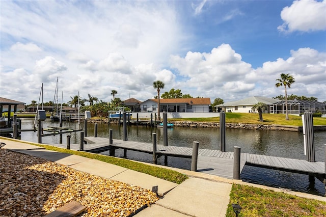 view of dock with a residential view and a water view