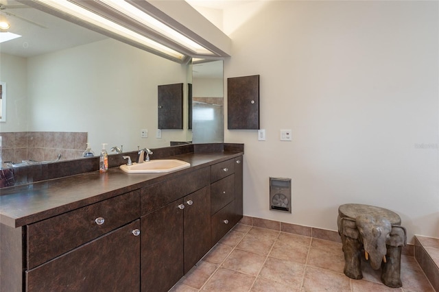 bathroom featuring ceiling fan, vanity, and tile patterned flooring