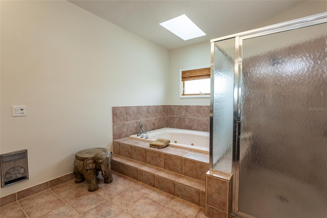 bathroom with a tub with jets, a shower stall, and a skylight