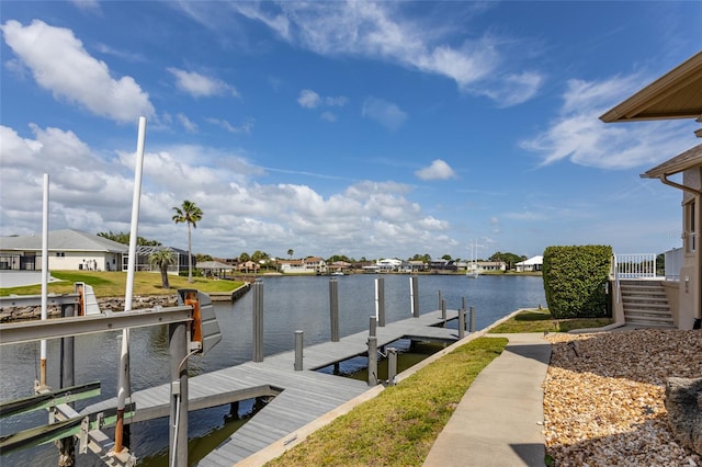 dock area with a residential view and a water view