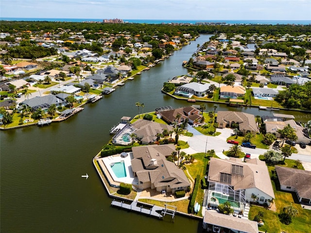 drone / aerial view with a water view and a residential view