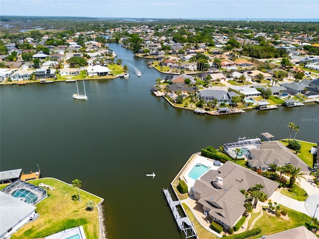 birds eye view of property featuring a water view and a residential view