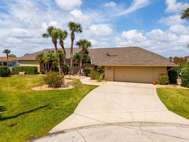 ranch-style home with a front lawn, driveway, and an attached garage