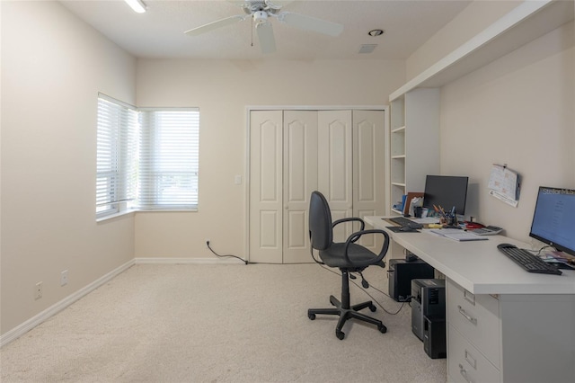 carpeted home office featuring visible vents, a ceiling fan, and baseboards