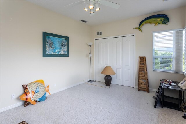 rec room with visible vents, a ceiling fan, and carpet flooring
