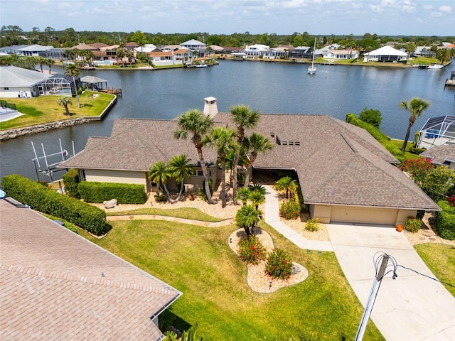 birds eye view of property with a residential view and a water view