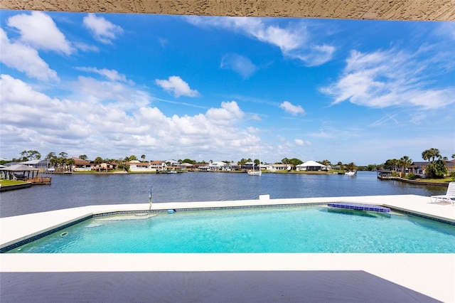 outdoor pool featuring a residential view and a water view