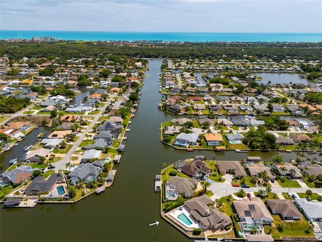 birds eye view of property with a residential view and a water view