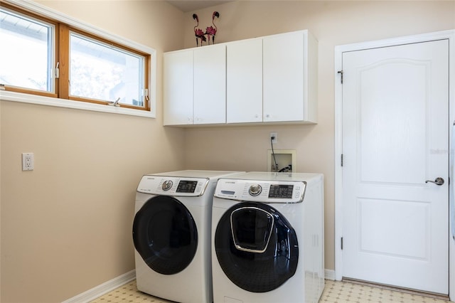 clothes washing area with baseboards, cabinet space, washing machine and clothes dryer, and light floors