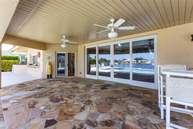 view of patio featuring ceiling fan and french doors