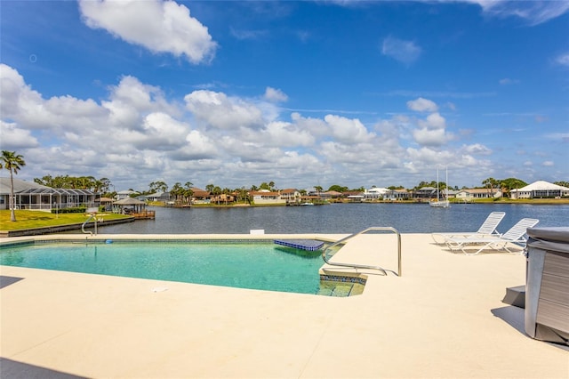 outdoor pool featuring a water view, a patio, and a residential view