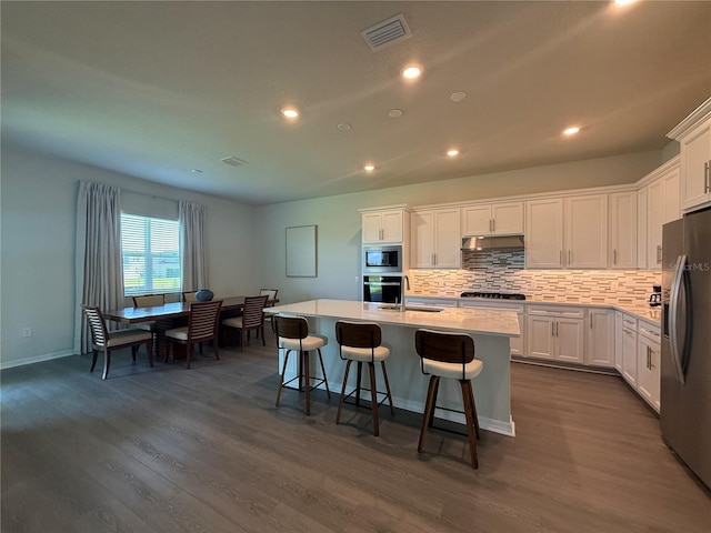 8243 Fenton St, Orlando, FL 32836 - kitchen featuring stainless steel appliances, dark wood-type flooring, white cabinetry, and recessed lighting